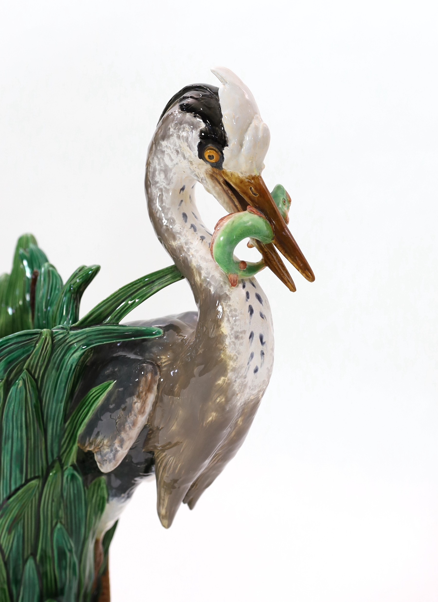 A Minton majolica life-size ‘heron’ stickstand, initialled J.H. for the modeller John Henk, c.1905, 44cm wide 76cm high
